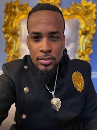 a man with dreadlocks and a lion on his head